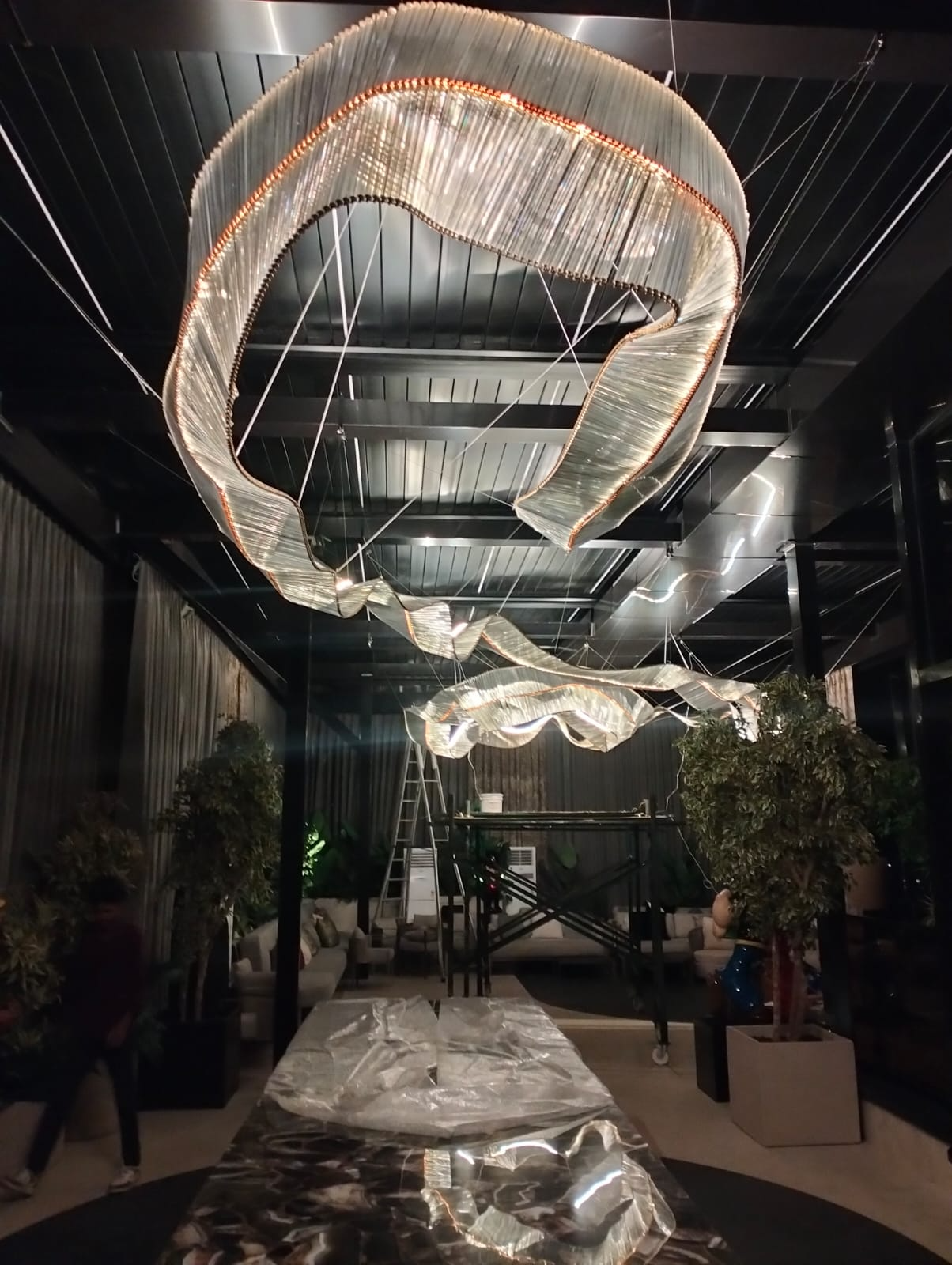 Bespoke ribbon chandelier installation in a luxury Mumbai property featuring large double-height interiors.